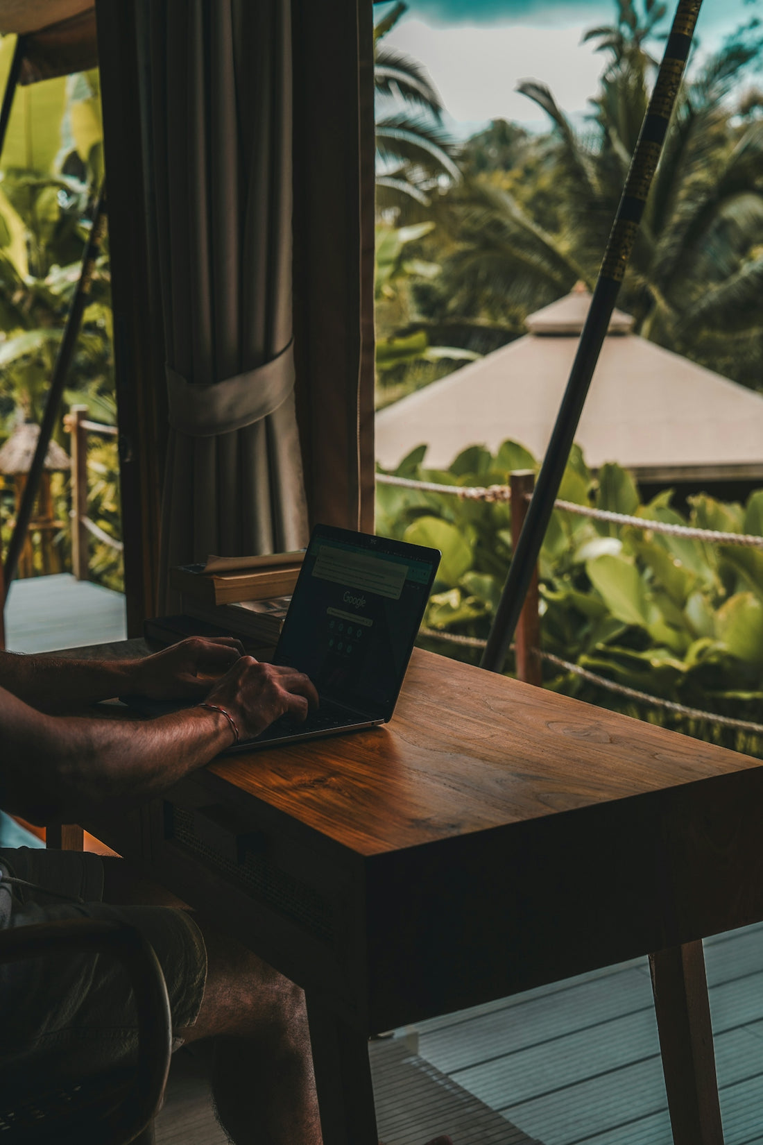 A man sitting at a table using a laptop computer